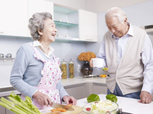 independent living couple cooking in senior living community