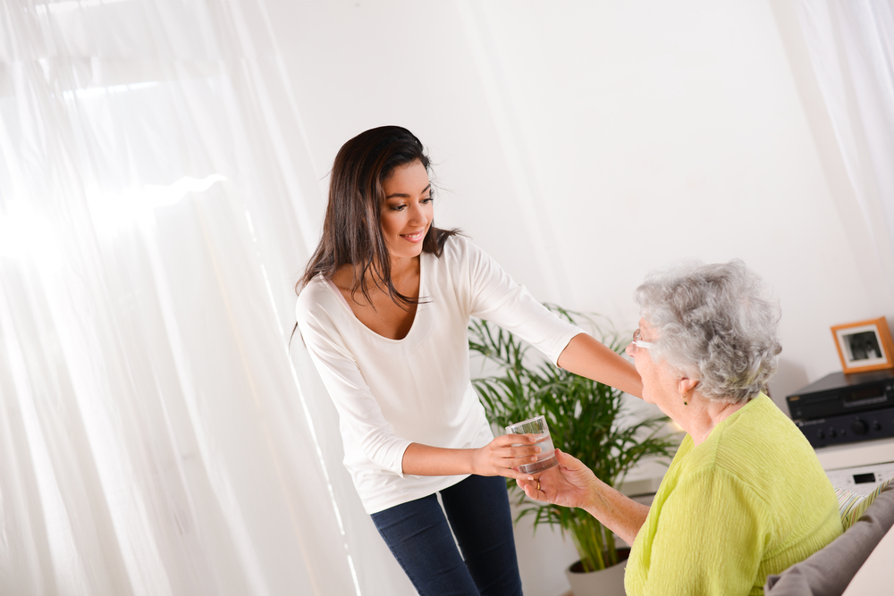 Woman Helping with Senior Living Community Member